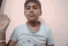 a young boy wearing a t-shirt that says ' it 's a race ' on it