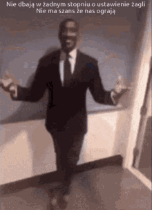 a man in a suit and tie is dancing in a room