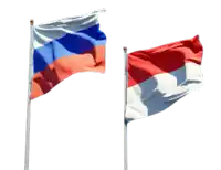 a russian flag and a french flag are waving in the wind against a white background