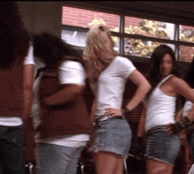 a group of young women are standing in a hallway