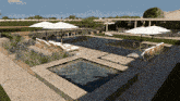 a large swimming pool with umbrellas and chairs