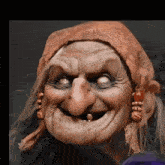 an old woman with a scarf around her head is smiling