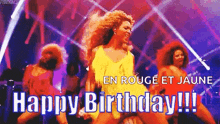 a woman in a yellow dress is dancing on a stage in front of a group of dancers and the words happy birthday !!!