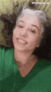a woman in a green shirt is smiling with pixverse.ai on the bottom