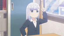 a girl with white hair and blue eyes is sitting at a desk in front of a window