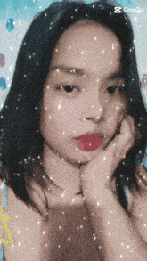 a girl 's face is surrounded by sparkles and the word capquit is on the bottom right