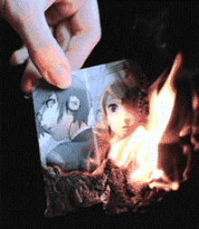 a person is burning a picture of a girl on a piece of paper