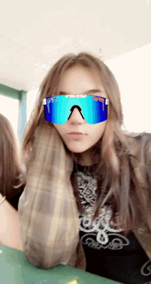 a girl is wearing a pair of blue pittsburgh sunglasses