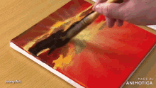 a person is painting on a canvas with the words made in animatica on the bottom right