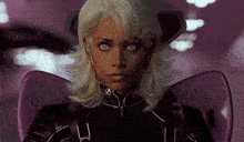 a woman with purple eyes is wearing a black jacket and purple wings