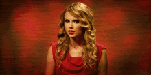 a woman in a red dress makes a funny face