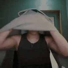 a person is covering their face with a white cloth