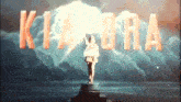 a statue of a woman stands in front of a sign that says kiara