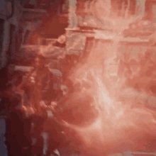 a group of people are standing in a room with red smoke coming out of the ceiling .