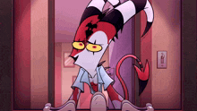 a cartoon character with horns and a tail is sitting on a door .