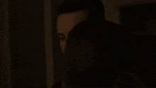 a man and a woman are hugging in a dark room