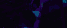 two women are standing on a balcony in a dark room