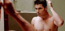 Fixing-hair Guy-in-looking-glass GIF