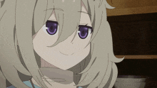 a girl with blonde hair and purple eyes smiles for the camera