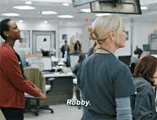 a woman in a scrub top says robby in a hospital
