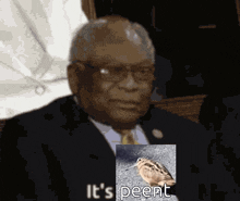 a man in a suit and tie is holding a picture of a bird with the words " it 's peent " below it