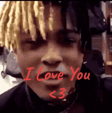 a close up of a person 's face with the words `` i love you '' written in red .