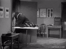a black and white photo of a room with a gifrun.com watermark