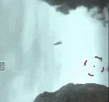 a plane is flying through a cloudy sky with a red target in the foreground .