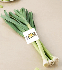 a bunch of green onions with a tag that says mob town