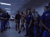 a man in a wrestling outfit is being escorted by police officers in a hallway