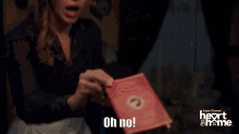 a person holding a book that says oh no on the bottom