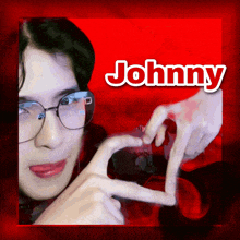 a person making a heart with their hands and the name johnny above them