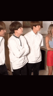 a group of people are standing next to each other in a room .