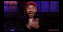 a man with a beard wearing a red hat that says chicago bulls