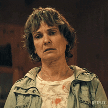a woman is wearing a netflix jacket