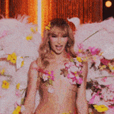 a naked woman with flowers on her chest has a tattoo on her stomach that says " nothing "