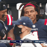 a patriots player is talking to a fan