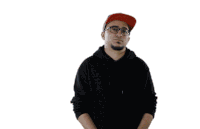 a man wearing glasses and a red hat is making a peace sign with his arms outstretched