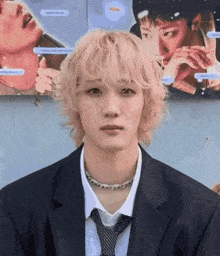 a man with blonde hair and a suit and tie