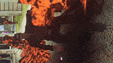a man in a video game is standing in front of fire