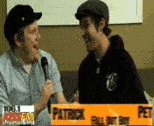 two men are talking to each other in front of a sign that says pet
