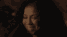 a woman is covering her mouth with her hand while crying .