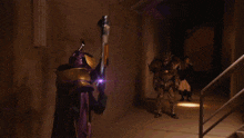 a person is holding a gun in a dark room surrounded by purple glowing objects