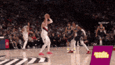 a basketball game is being played in front of a sign that says moda assist on it