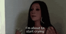 a woman says i 'm about to start crying in front of a wall