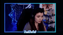 a woman wearing headphones is sitting in front of a computer screen with the words oh shit on it .