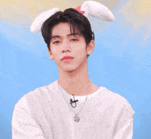 a man wearing bunny ears and gloves with korean writing on the bottom