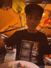 a man wearing a black shirt with a picture of a star on it