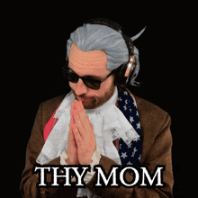 a man wearing a wig and sunglasses has the word thy mom written on his chest