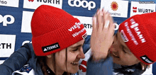 two women wearing red hats with terrex written on them